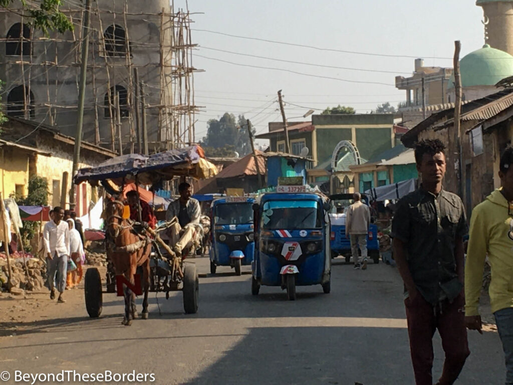 Street with tuk-tuks and horse pulled cart in Gondor, Ethiopia.