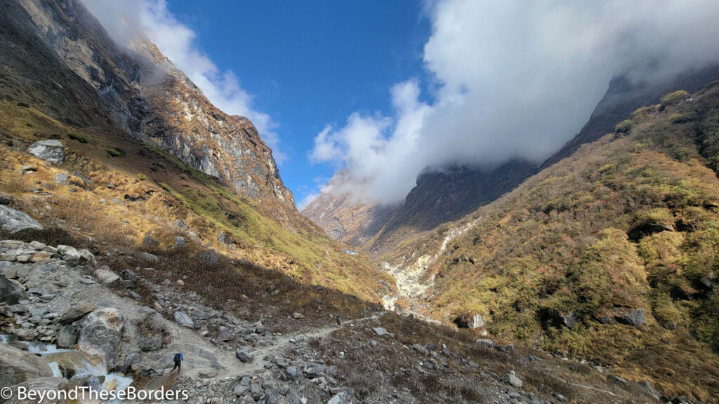 View of the trail through the valley.  Clouds hugging the tops of the hills.