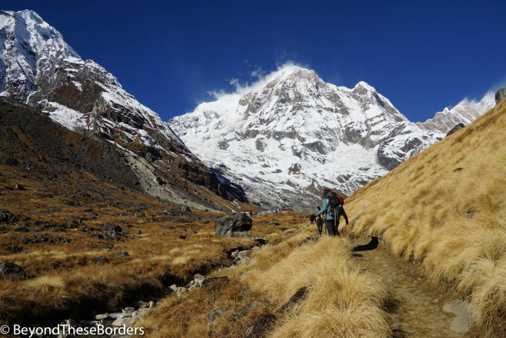 Clear view of Annapurna South over the tiny lodges as we look back towards basecamp on our hike away.