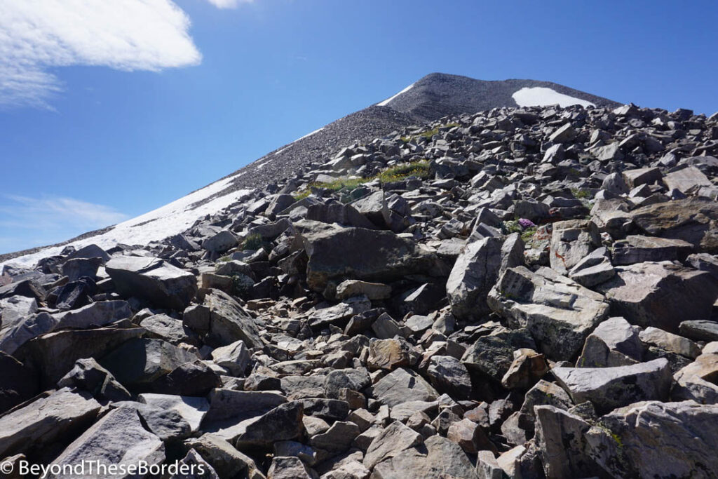 Very rocky trail leading towards the mountain peaks.