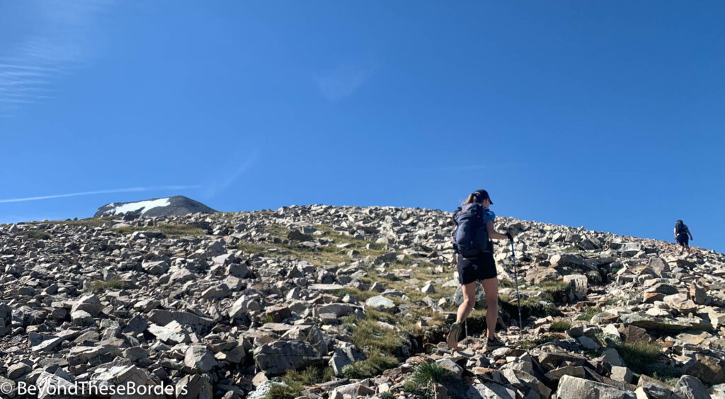 Picture of me hiking up a trail with large rocks scattered everywhere.  